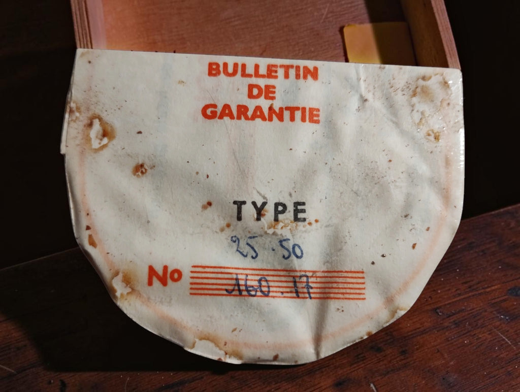 Original French Bulletin de Garantie for the Roch Paris Type 25-50 micrometer, showing age-related stains and wear.
