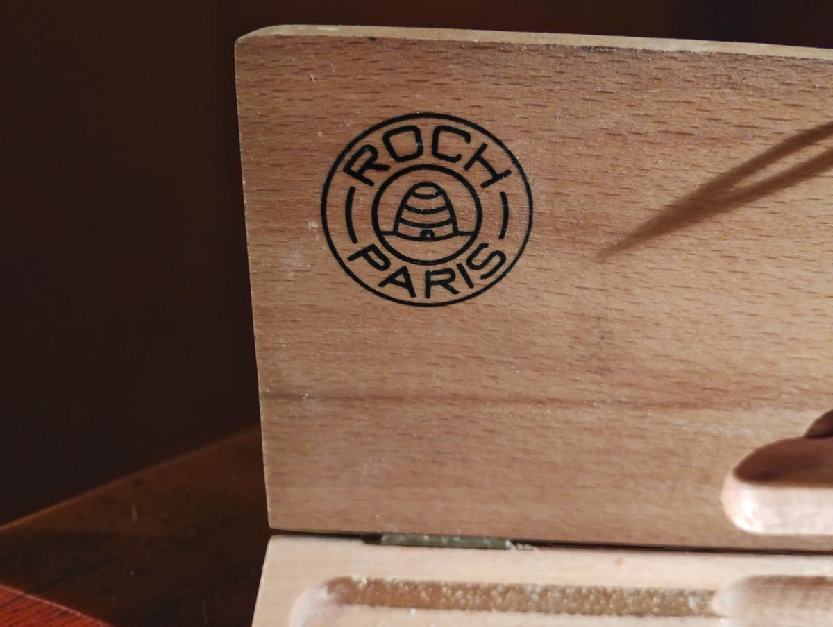 Close-up of the Roch Paris logo inside the wooden micrometer case.
