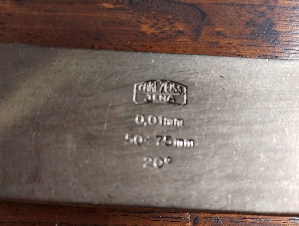 Close-up of the Carl Zeiss Jena maker’s mark and the 0.01 mm, 50–75 mm and 20° markings on the micrometer frame.

