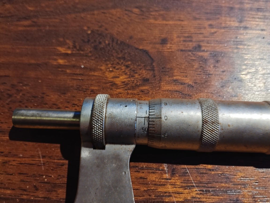 Close-up of the Carl Zeiss Jena micrometer’s graduated sleeve, rotating thimble and knurled adjustment grips.

