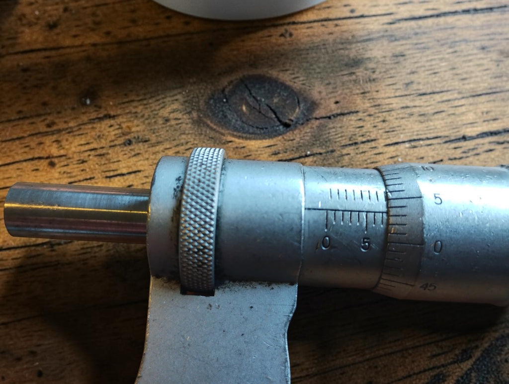 Close-up of the spindle, locking ring and graduated sleeve and thimble on a Carl Zeiss Jena outside micrometer.
