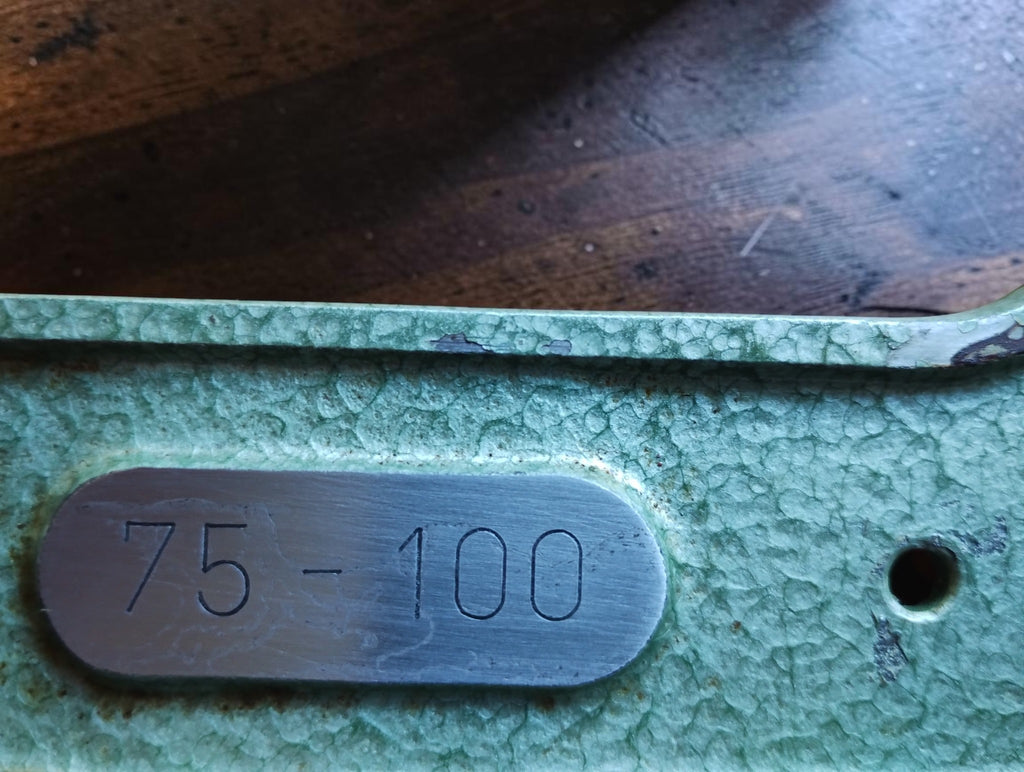 Close-up of the 75–100 range plate on the Mauser micrometer’s green hammer-finish frame.

