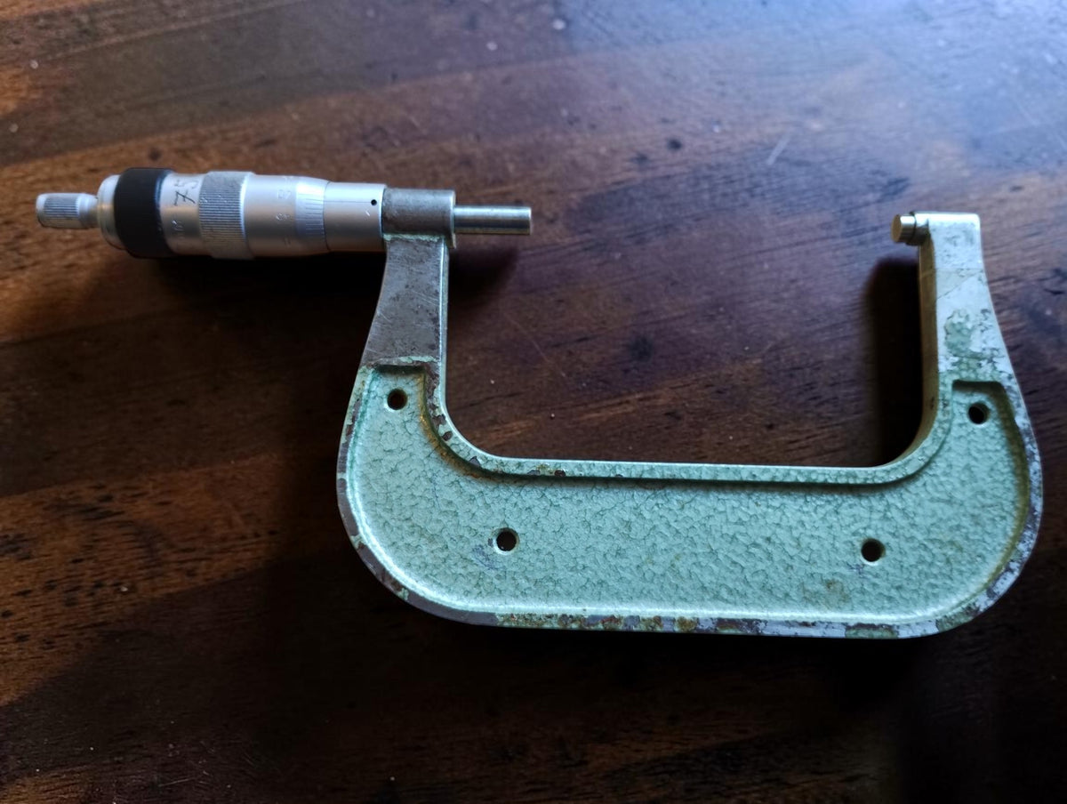 Reverse side of the Mauser 75–100 mm outside micrometer, showing wear and paint loss on the green frame.
