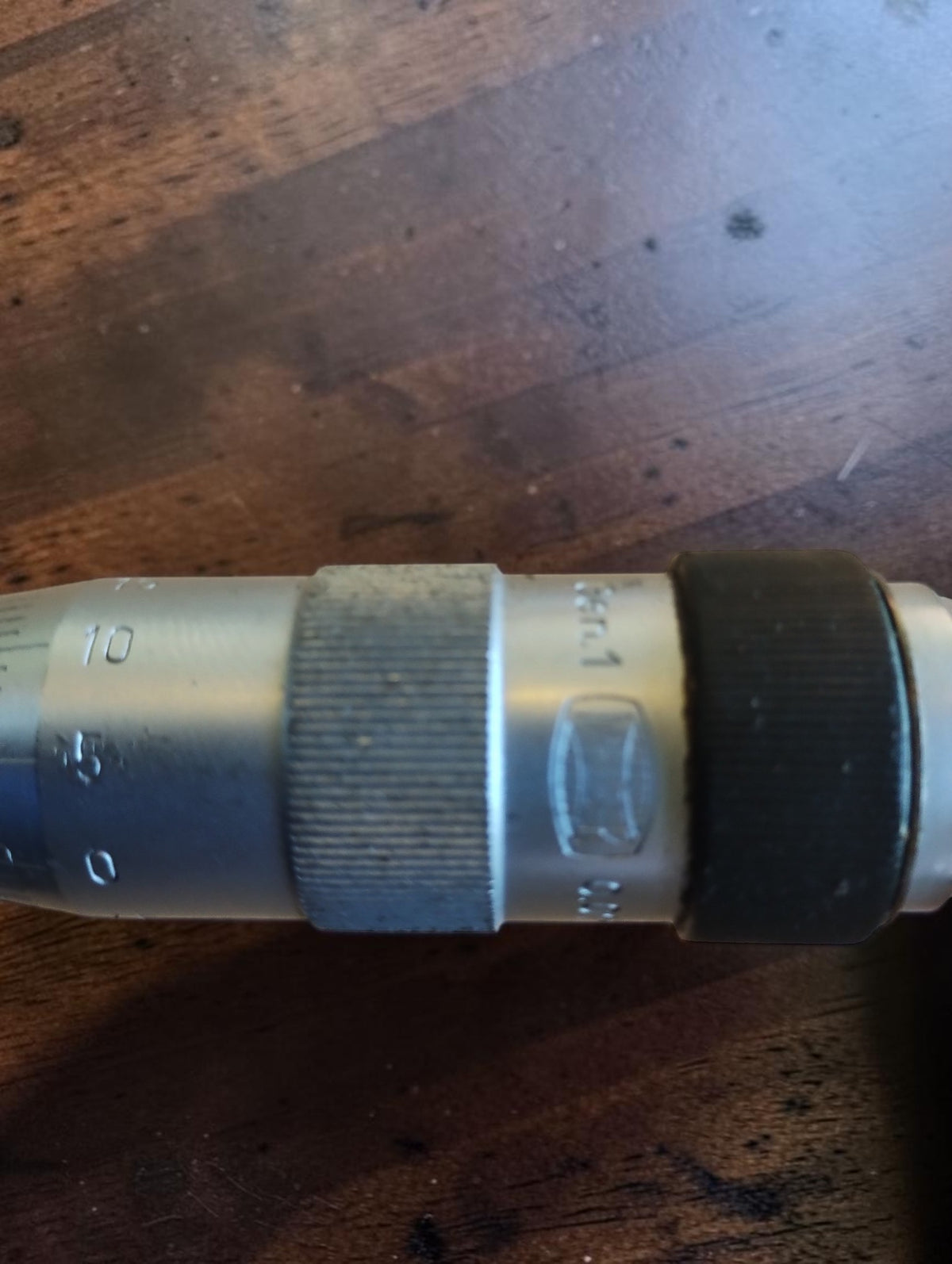 Detail of the Mauser micrometer thimble, engraved scale and maker’s mark beside the black ring.
