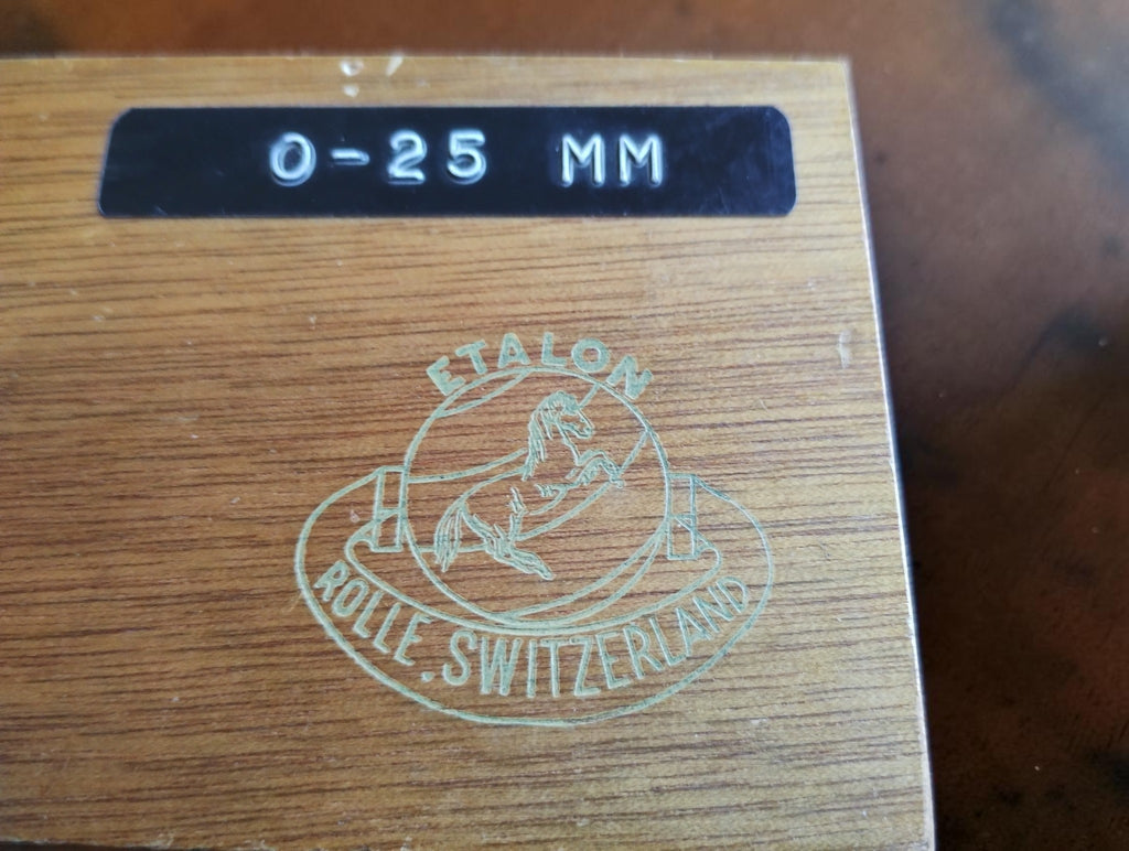 Etalon Rolle Switzerland logo and 0–25 mm label on the wooden micrometer case

