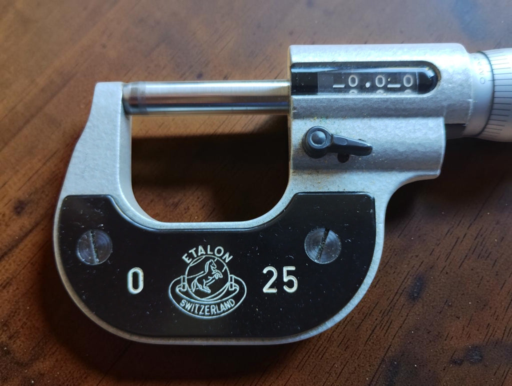 Close-up of the Etalon Switzerland logo, 0–25 mm range marking and mechanical counter display

