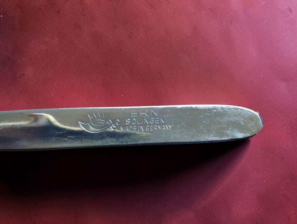 Close-up of the ERN Solingen Made in Germany stamp and maker's logo on the metal clipper handle
