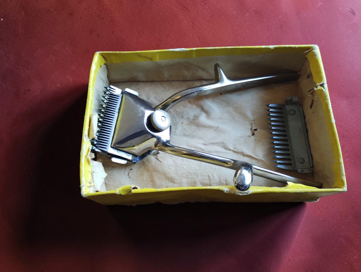 ERN Solingen manual hair clipper and comb attachment inside the worn vintage cardboard box

