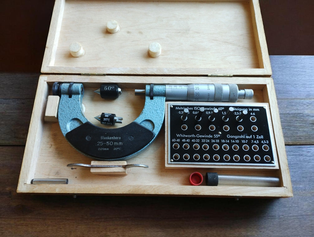 Blankenhorn 25–50 mm thread micrometer in an open wooden case with accessories and a metric and Whitworth thread chart.
