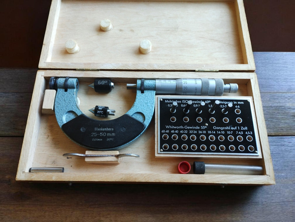 Blankenhorn 25–50 mm thread micrometer in an open wooden case with accessories and a metric and Whitworth thread chart.

