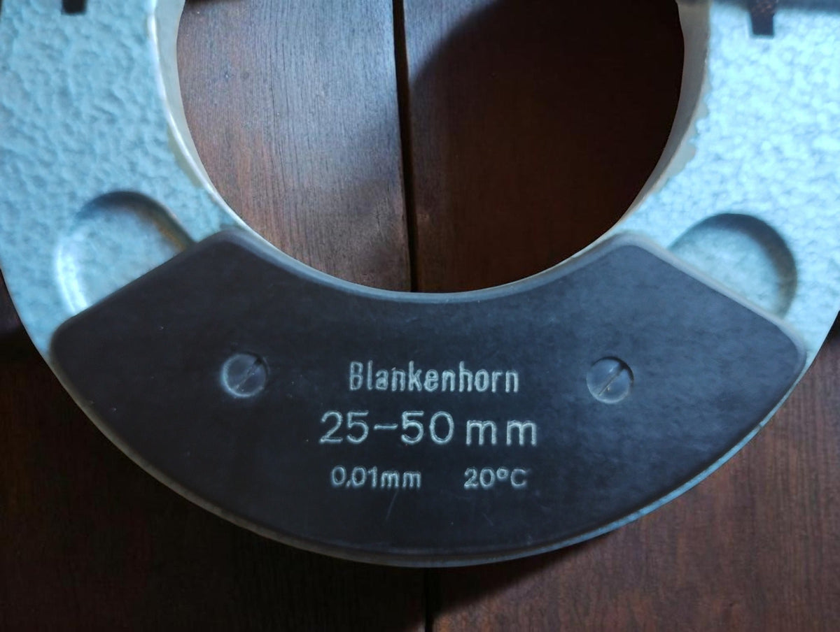 Detail of the black grip plate on the Blankenhorn thread micrometer, showing the brand, 25–50 mm range and 0.01 mm graduations.
