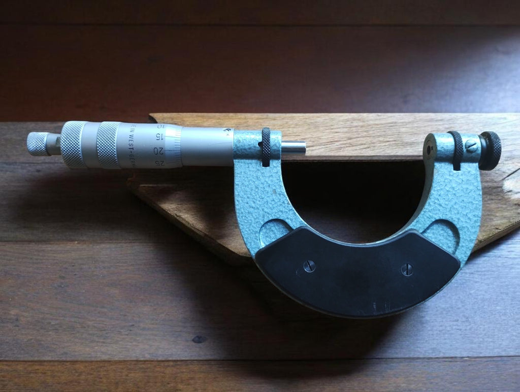 Rear view of the Blankenhorn thread micrometer showing the metal frame, black grip plate and knurled adjustment controls.
