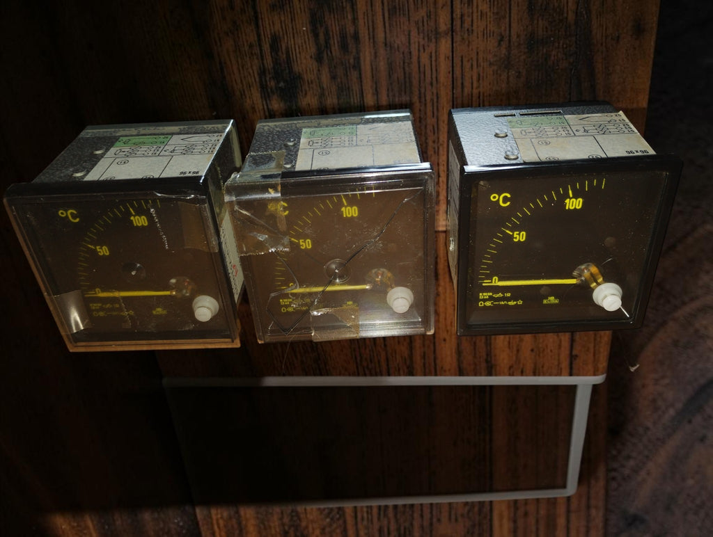 Set of three Hartmann & Braun THB 72 analog temperature meters with black dials and yellow scales
