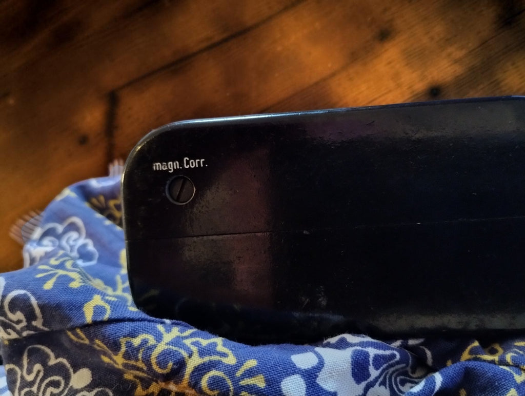 Side detail of the Gossen ISOGNOM black housing showing the adjustment screw marked magn. Corr.
