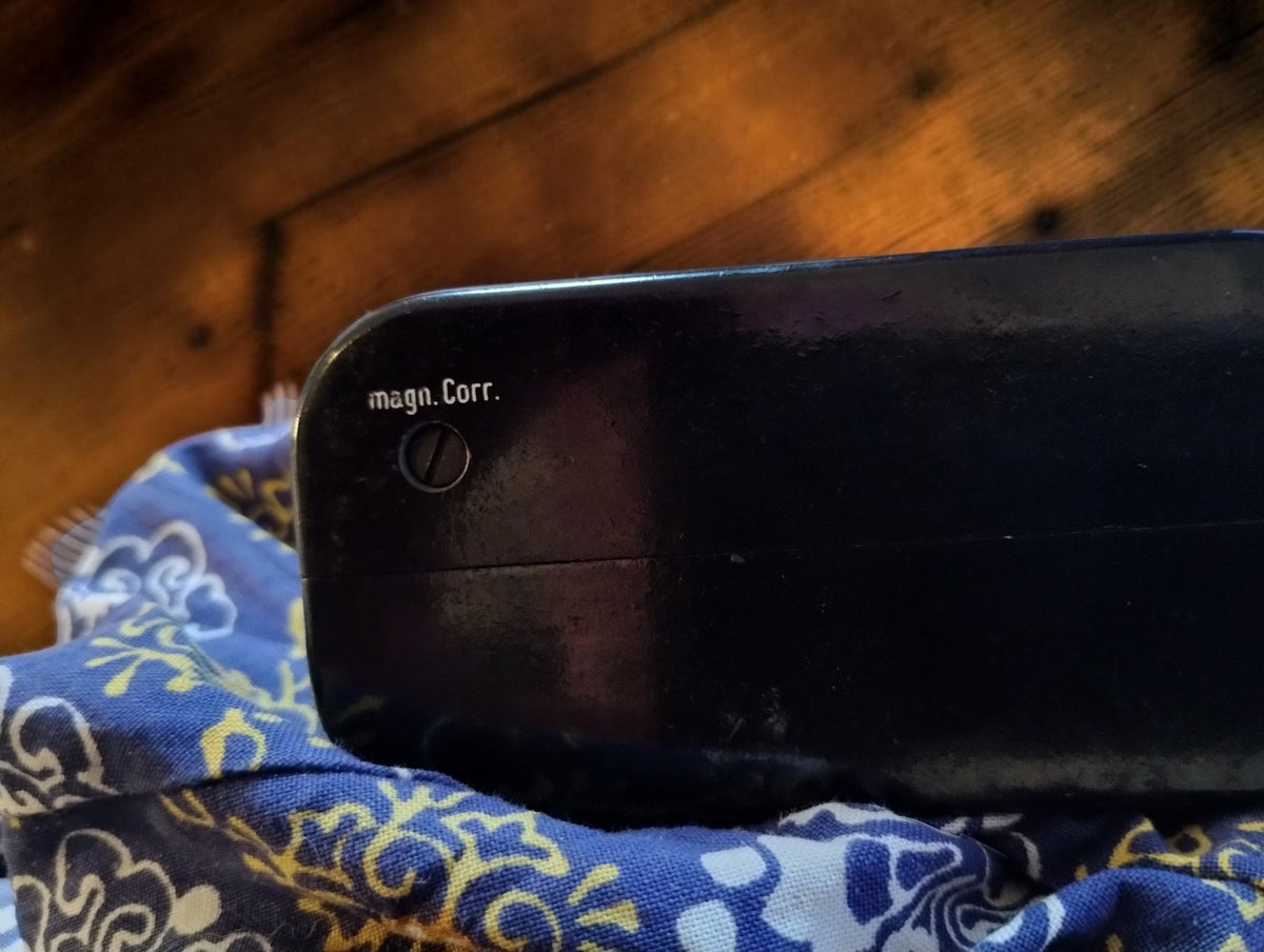 Side detail of the Gossen ISOGNOM black housing showing the adjustment screw marked magn. Corr.
