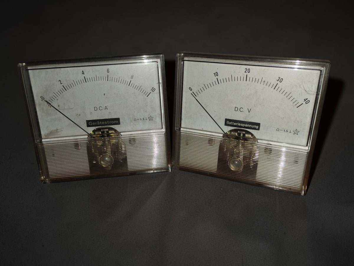 Pair of vintage analog panel meters, 0–10 A DC ammeter and 0–40 V DC voltmeter, shown from the front
