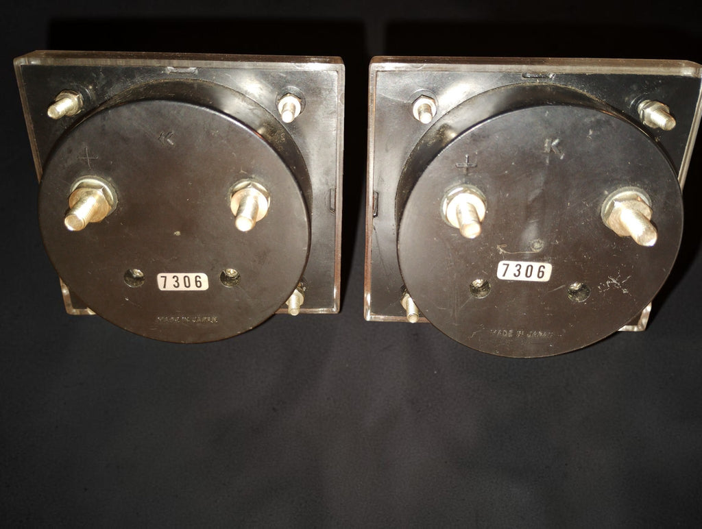 Rear view of both vintage panel meters showing connection terminals, mounting studs and 7306 markings
