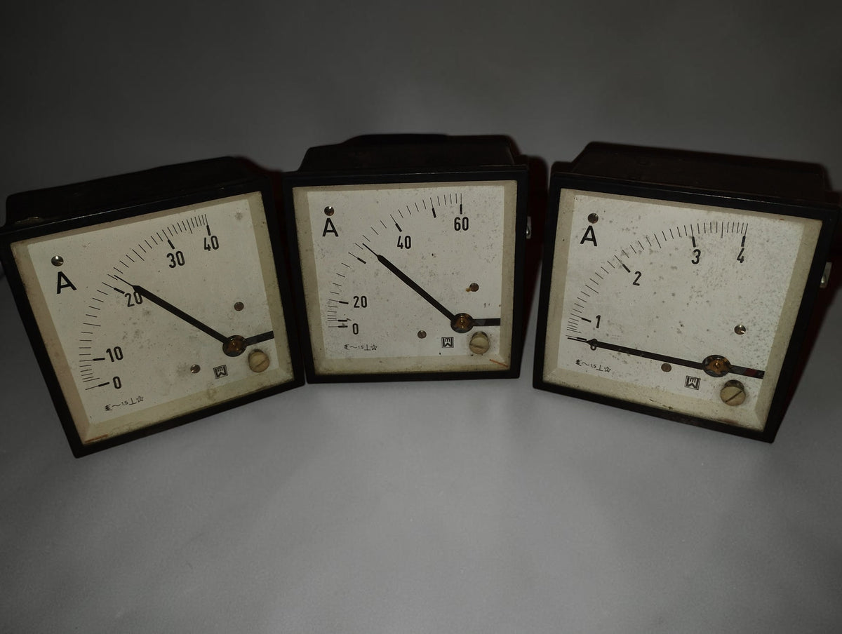Three vintage EAW Berlin-Treptow AC ammeters with pale dials, black pointers and dark square frames, front view
