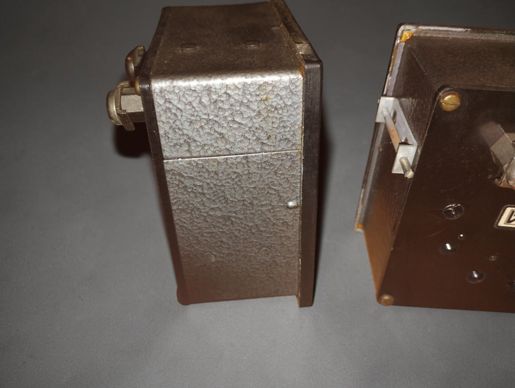 Side view of a vintage EAW Berlin-Treptow ammeter showing its textured metal housing and rear mounting hardware
