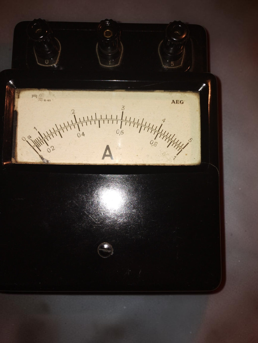 Vintage AEG analog ammeter with a black housing, ivory-colored dial, and 0–1 and 0–5 A scales.
