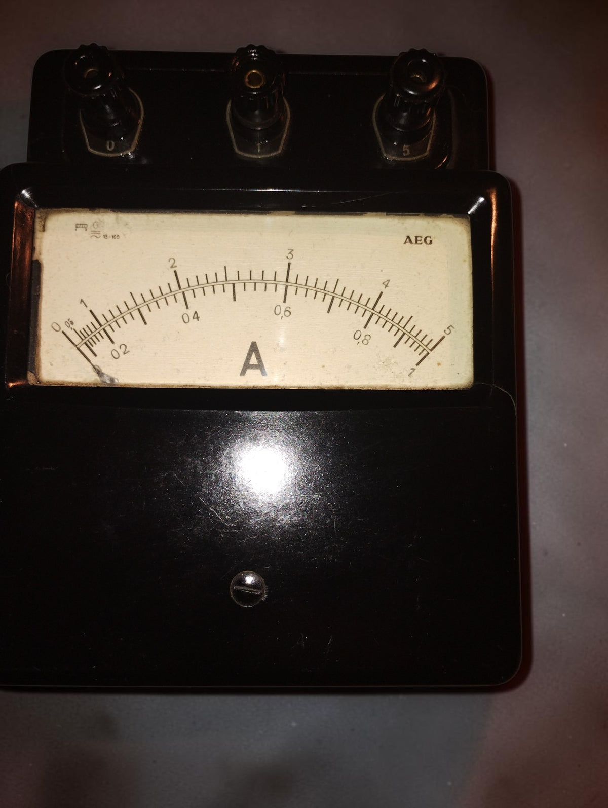 Vintage AEG analog ammeter with a black housing, ivory-colored dial, and 0–1 and 0–5 A scales.
