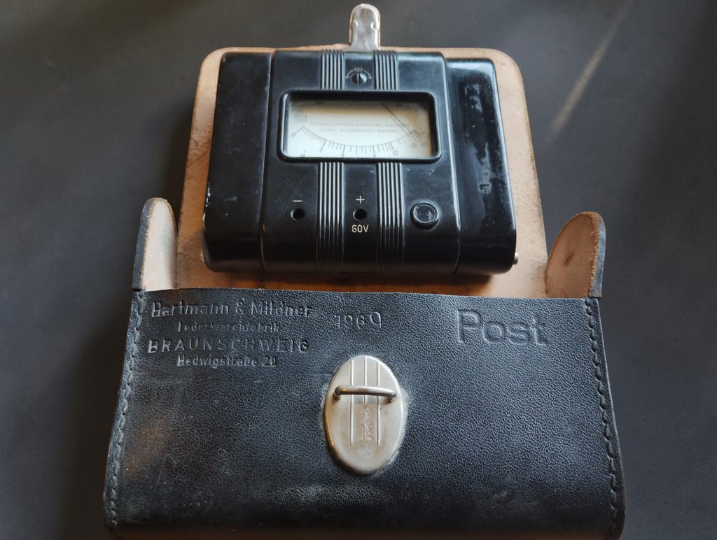 Vintage Gossen Post 60 V megohmmeter with open Hartmann & Mildner leather carrying case dated 1960.
