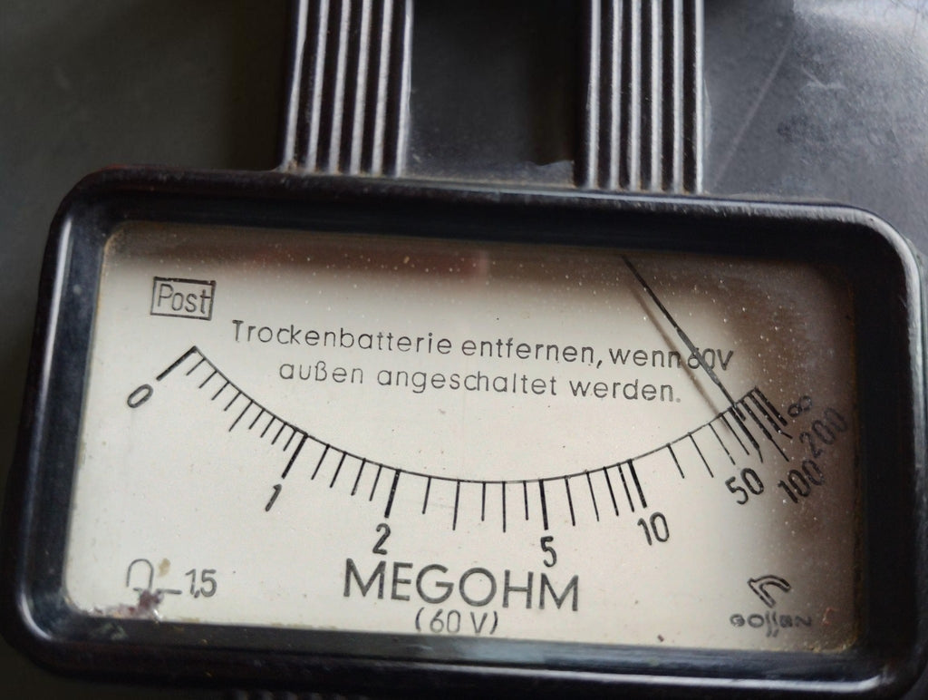 Close-up of the Gossen megohmmeter dial with Post marking, megohm scale and 60 V designation.
