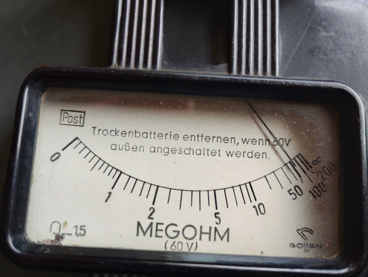 Close-up of the Gossen megohmmeter dial with Post marking, megohm scale and 60 V designation.
