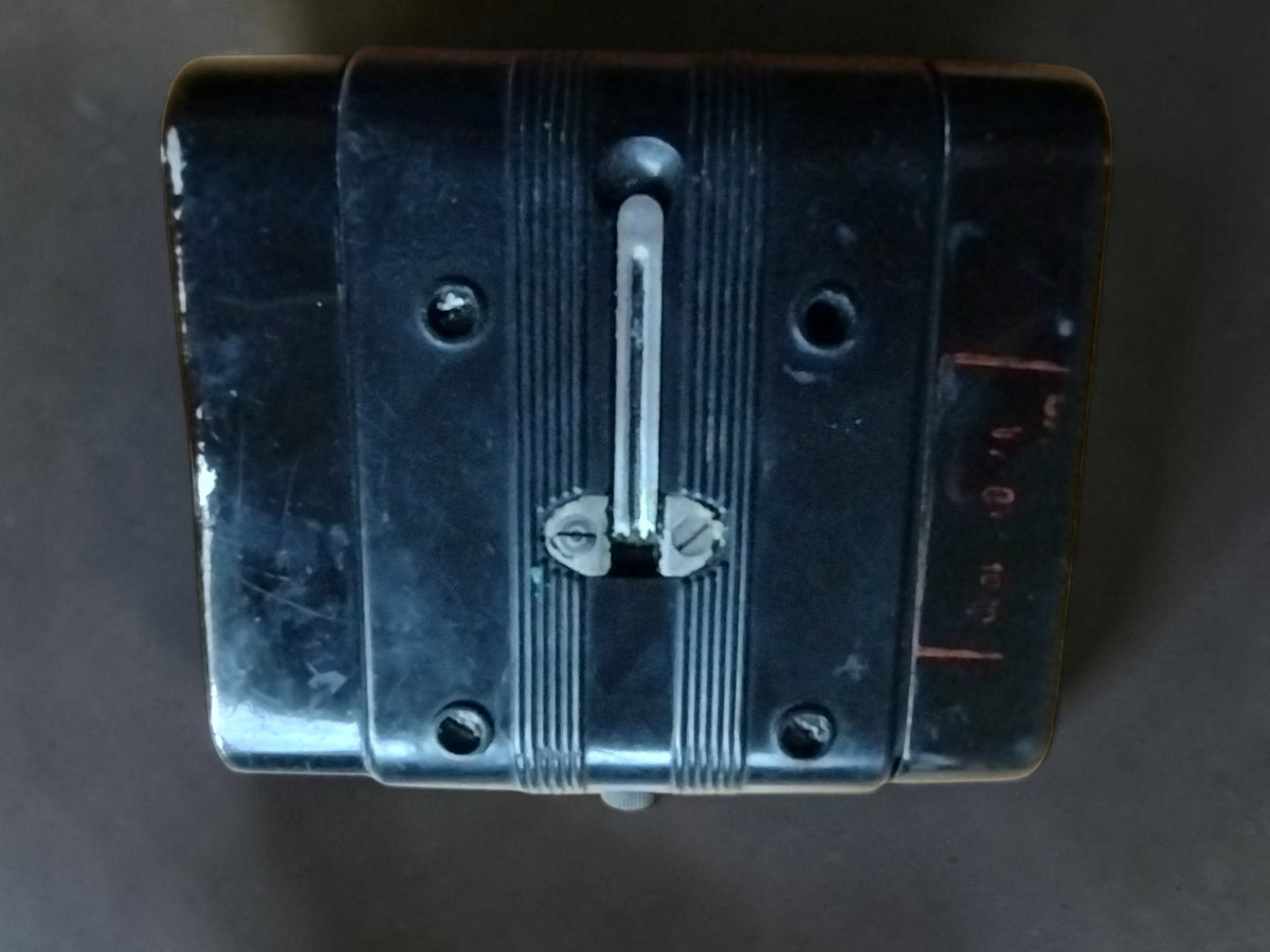 Rear view of the Gossen Post megohmmeter showing the metal clip and wear on the black housing.
