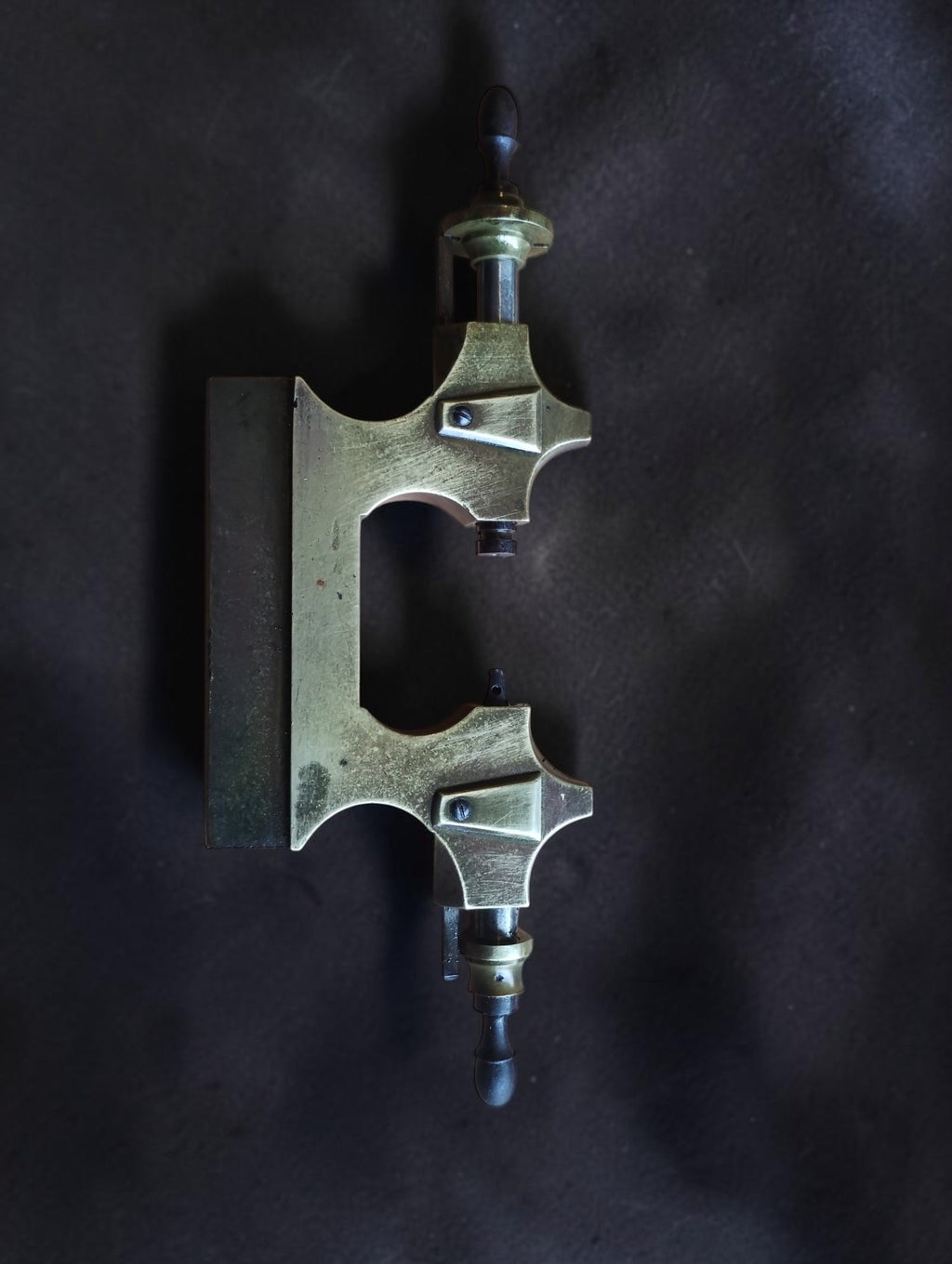 19th-century Jacot pivot tool frame with brass body, steel runners and wooden handles, side view
