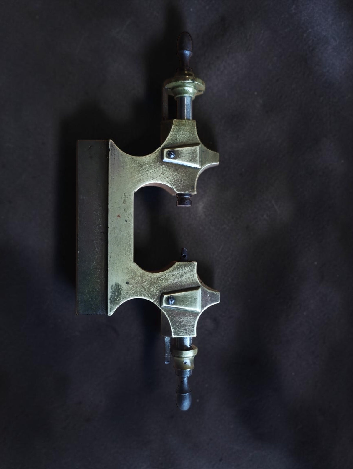 19th-century Jacot pivot tool frame with brass body, steel runners and wooden handles, side view
