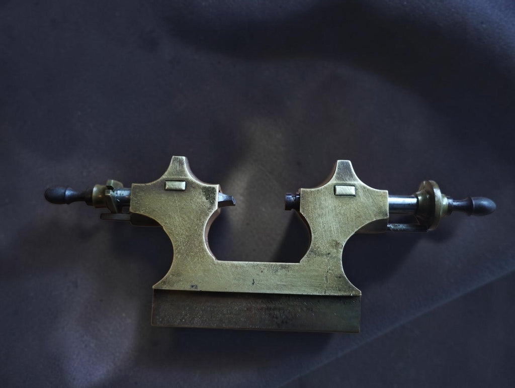 Antique brass Jacot pivot tool frame with two steel runners and wooden handles, reverse view
