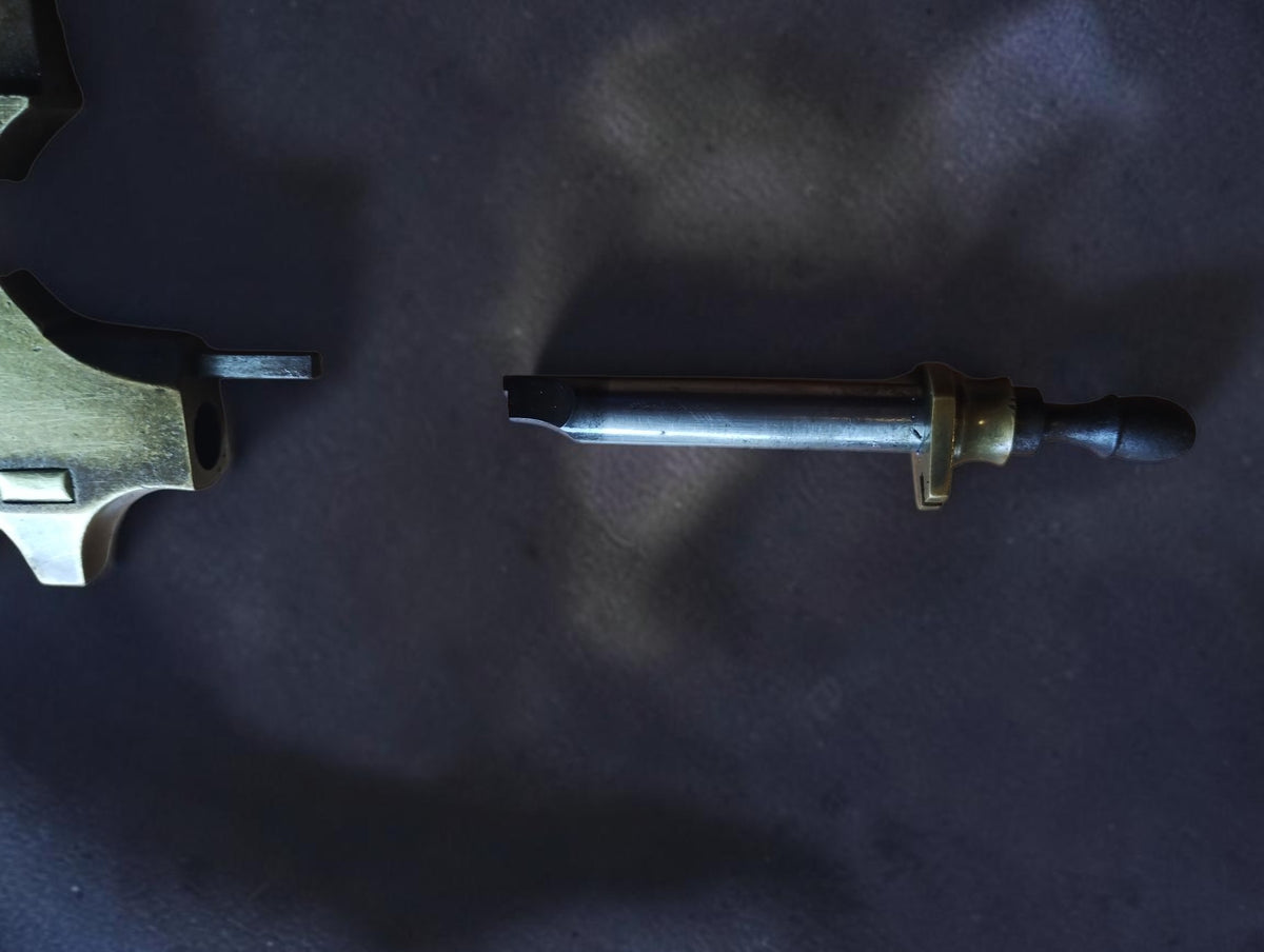 Detached steel runner with wooden handle beside the antique brass Jacot pivot tool frame
