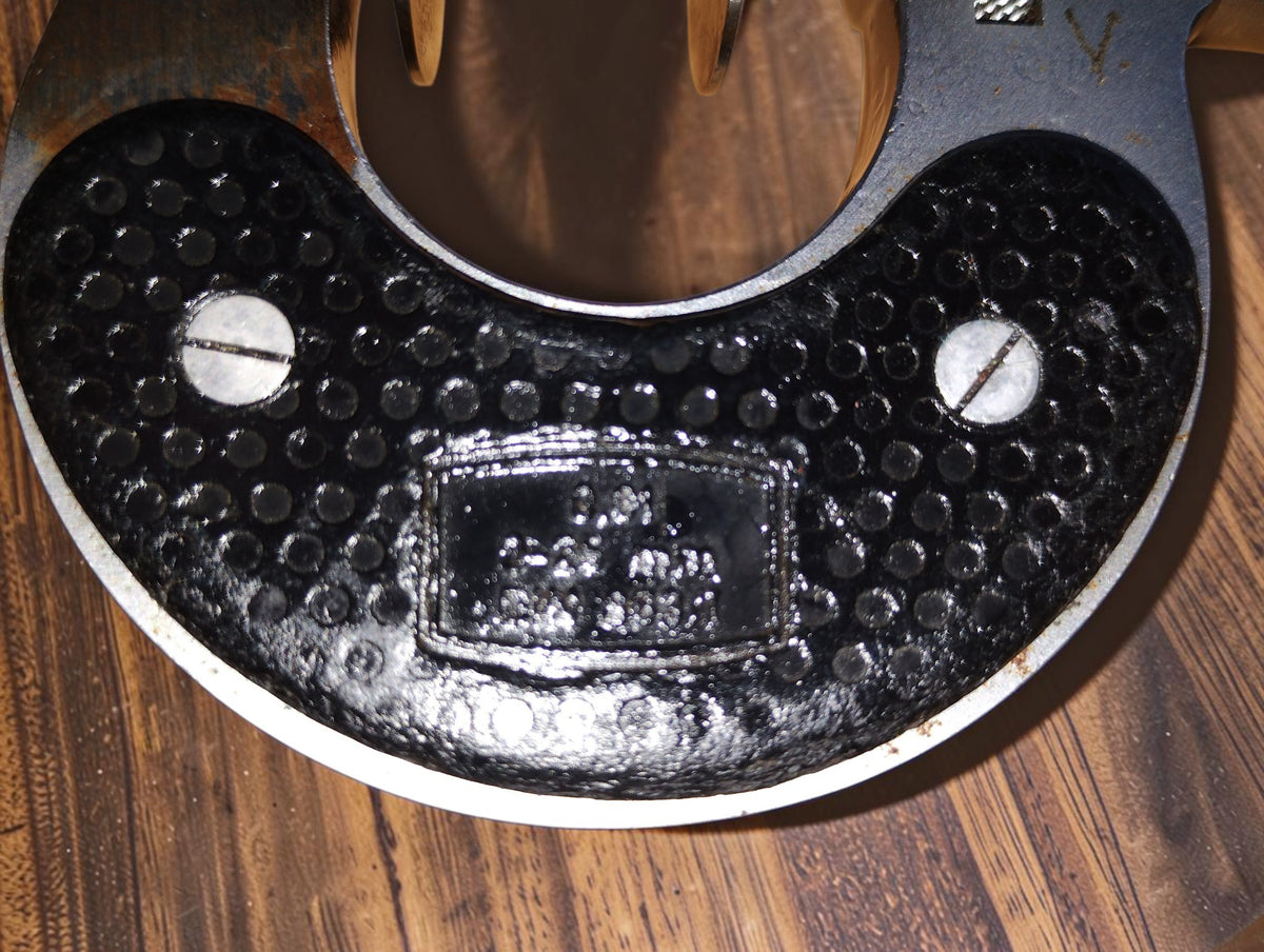 Close-up of the textured black frame and identification plate on the Steinmeyer disc micrometer
