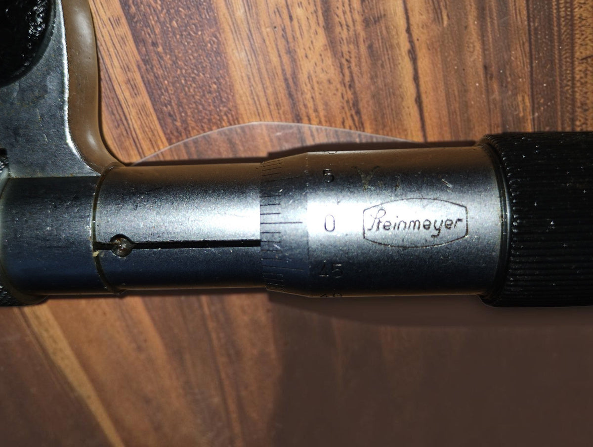 Close-up of the Steinmeyer logo and graduated sleeve on the vintage 0–25 mm disc micrometer
