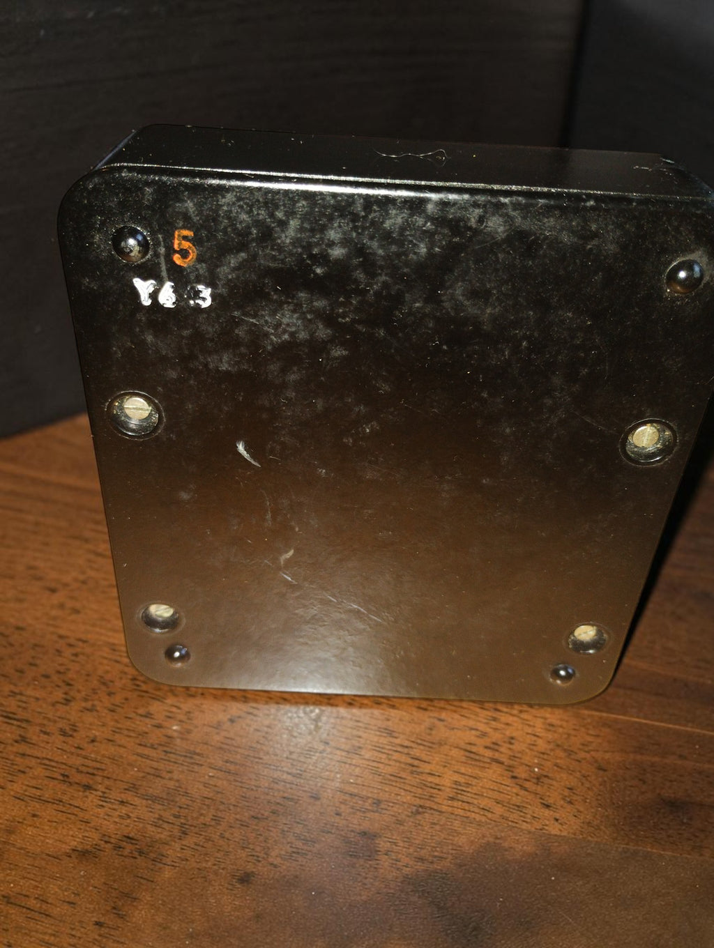 Rear view of the vintage galvanometer with mounting screws, painted markings, and visible surface wear.
