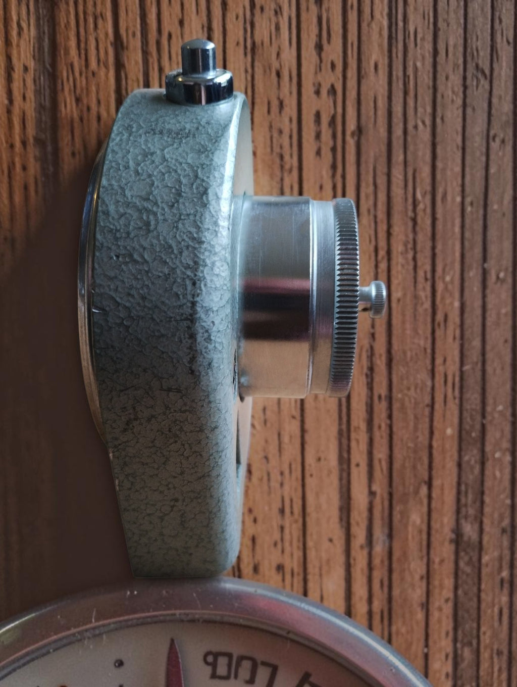 Side view of the Dräger Narkoseuhr showing the gray-green housing, projecting clock mechanism, and top push button
