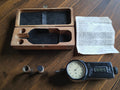 Vintage IVO Probator mechanical hand tachometer with open wooden case, two contact attachments and original German instruction sheet
