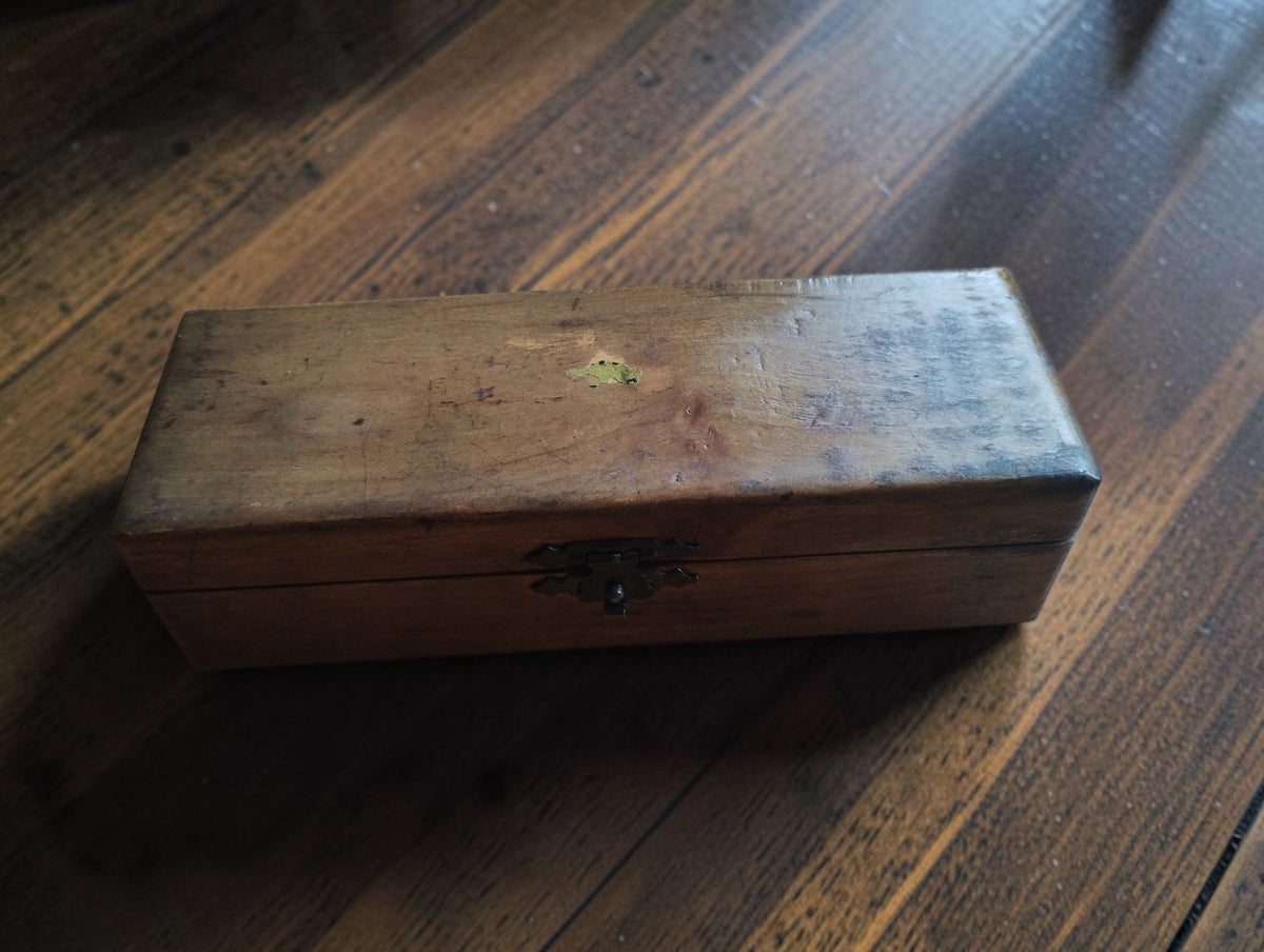 Closed wooden storage case for the IVO Probator hand tachometer, showing the front clasp and age-related wear
