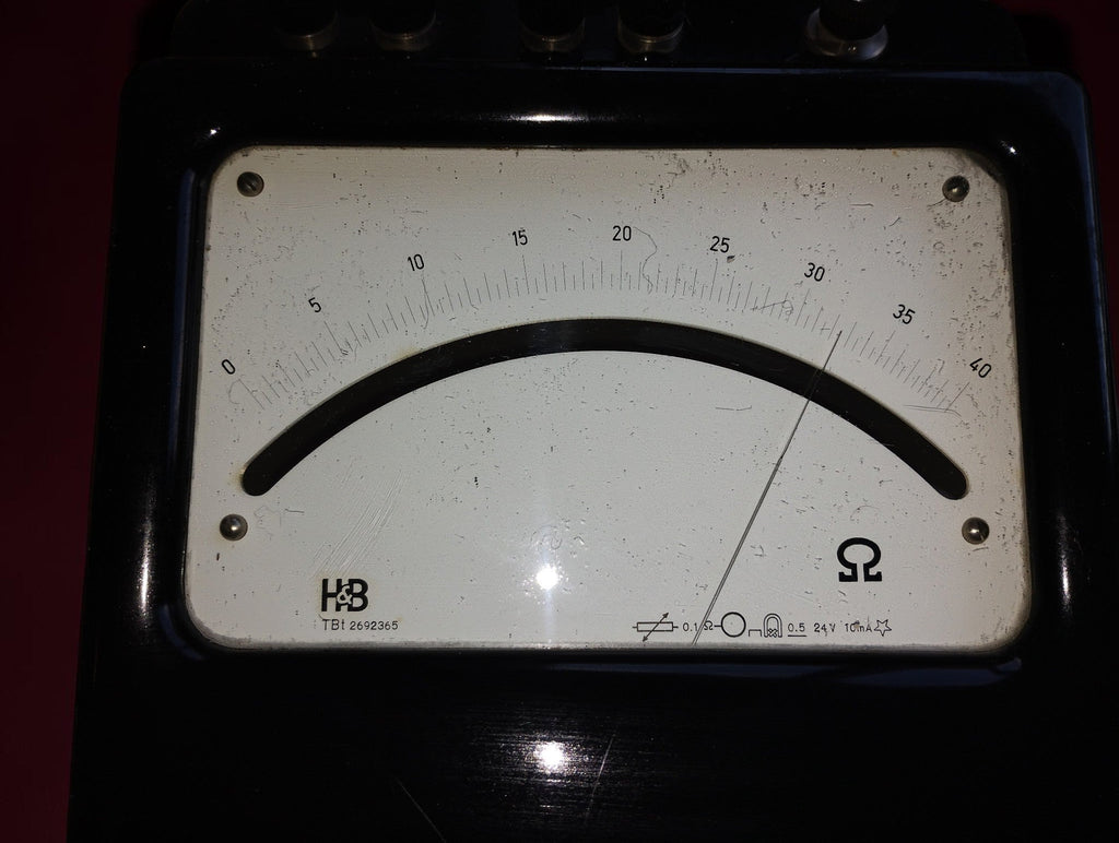 Close-up of the H&B analog ohmmeter dial showing the 0–40 ohm scale, pointer and surface marks
