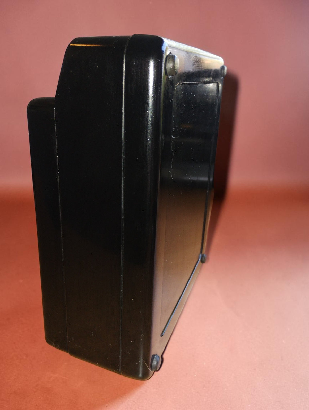 Side view of the H&B vintage resistance meter showing the depth and profile of its black case
