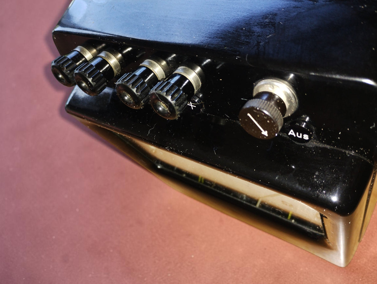 Angled close-up of the H&B ohmmeter terminals and rotary switch, showing wear on the black case
