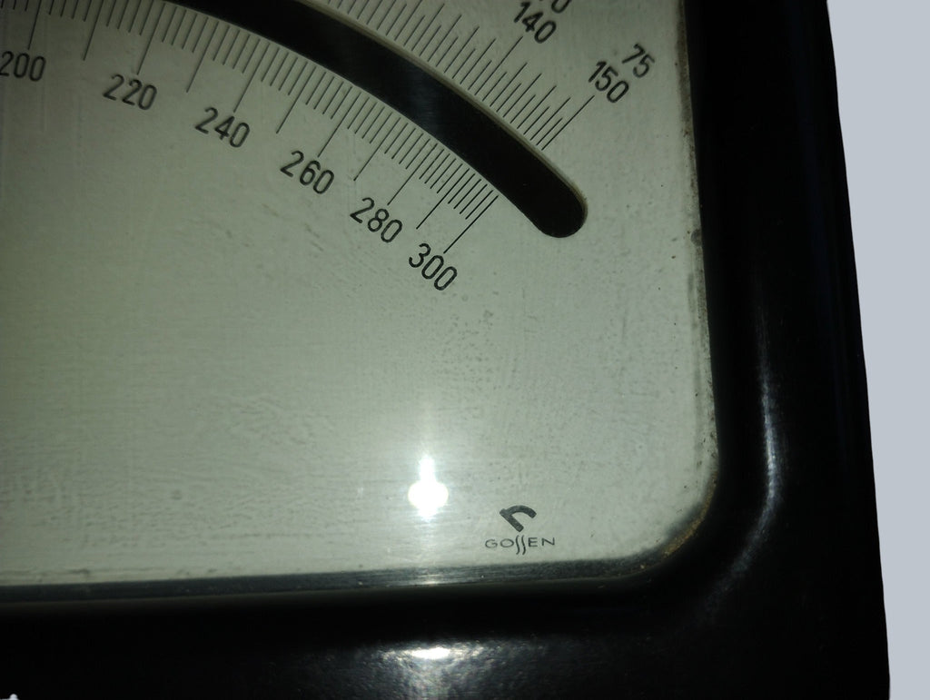 Gossen logo and upper ends of the voltage scales on the vintage analog voltmeter dial.
