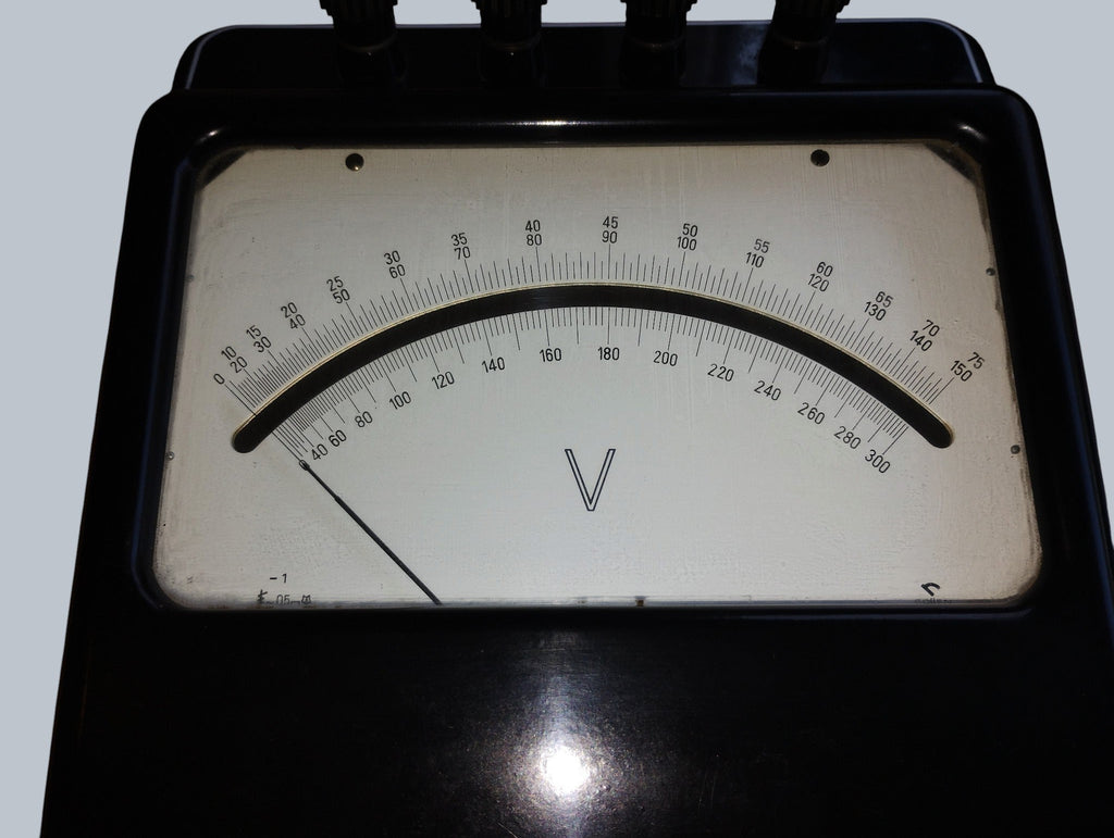Full dial of the vintage Gossen laboratory voltmeter, showing multiple voltage scales and the V marking.
