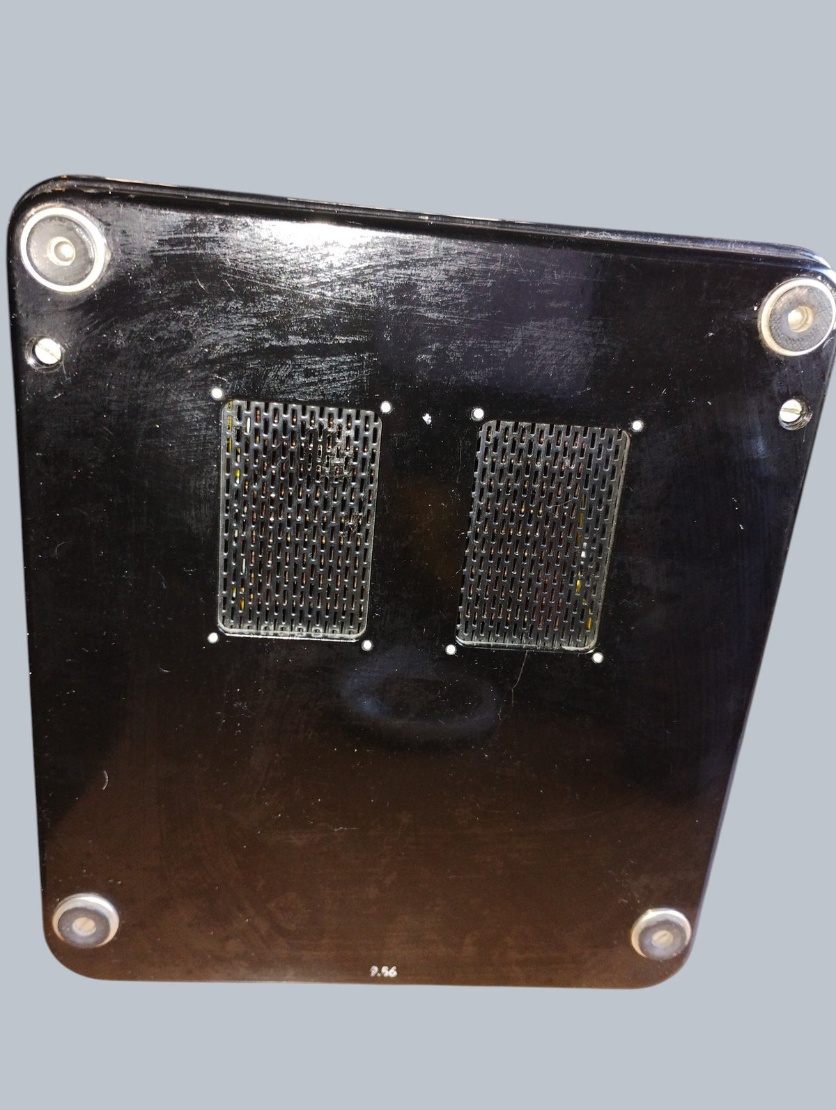 Underside of the Gossen voltmeter with two ventilation grilles, four feet and visible surface scratches.
