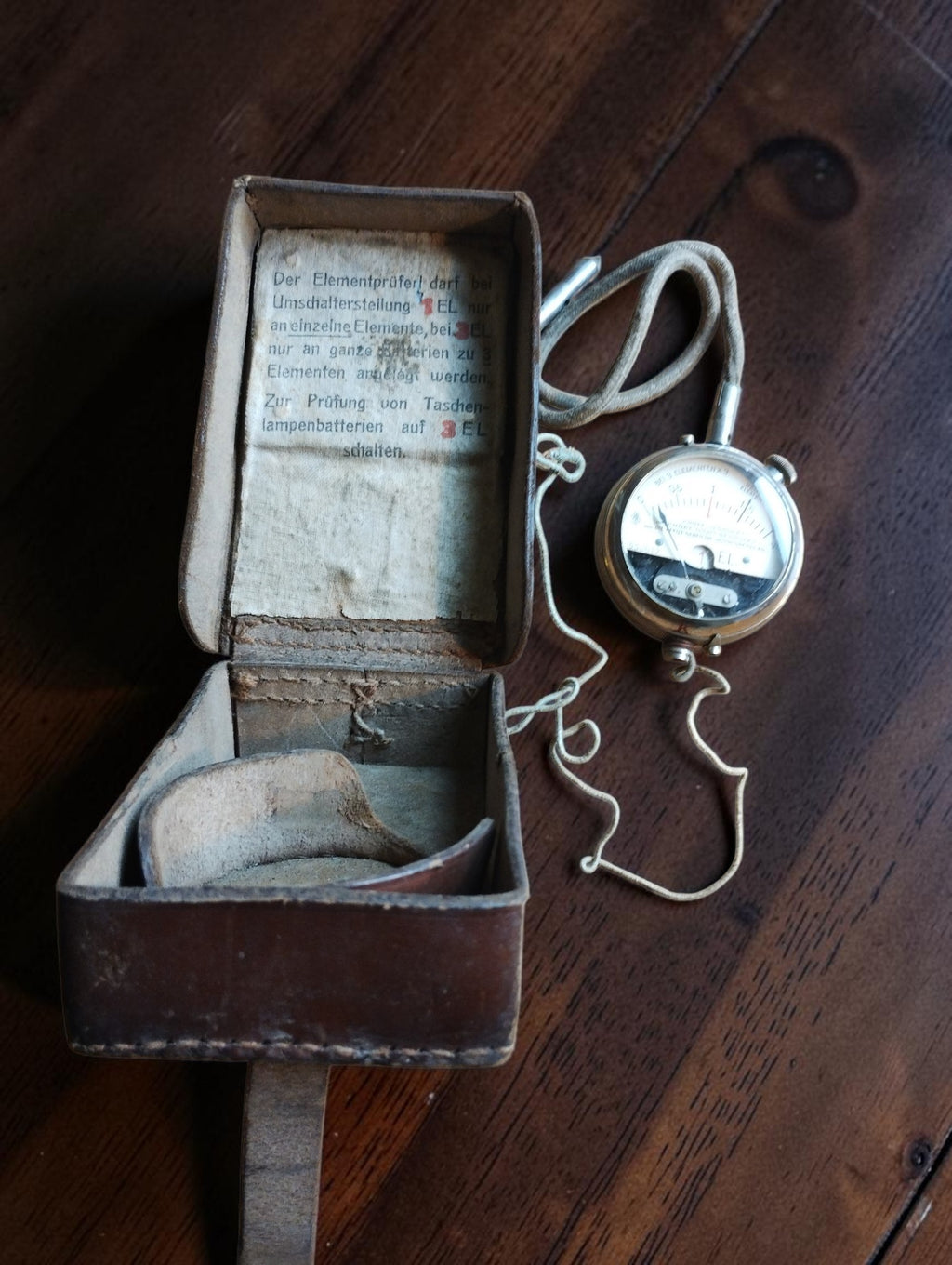 Siemens & Halske Elementprüfer battery tester with cloth-covered lead, test probe and open leather case.
