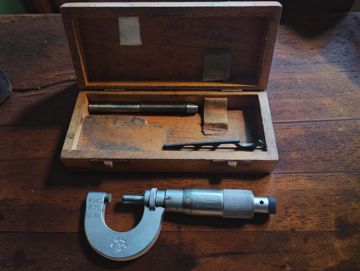 Vintage Steinmeyer 0–25 mm outside micrometer with open wooden case and included accessories
