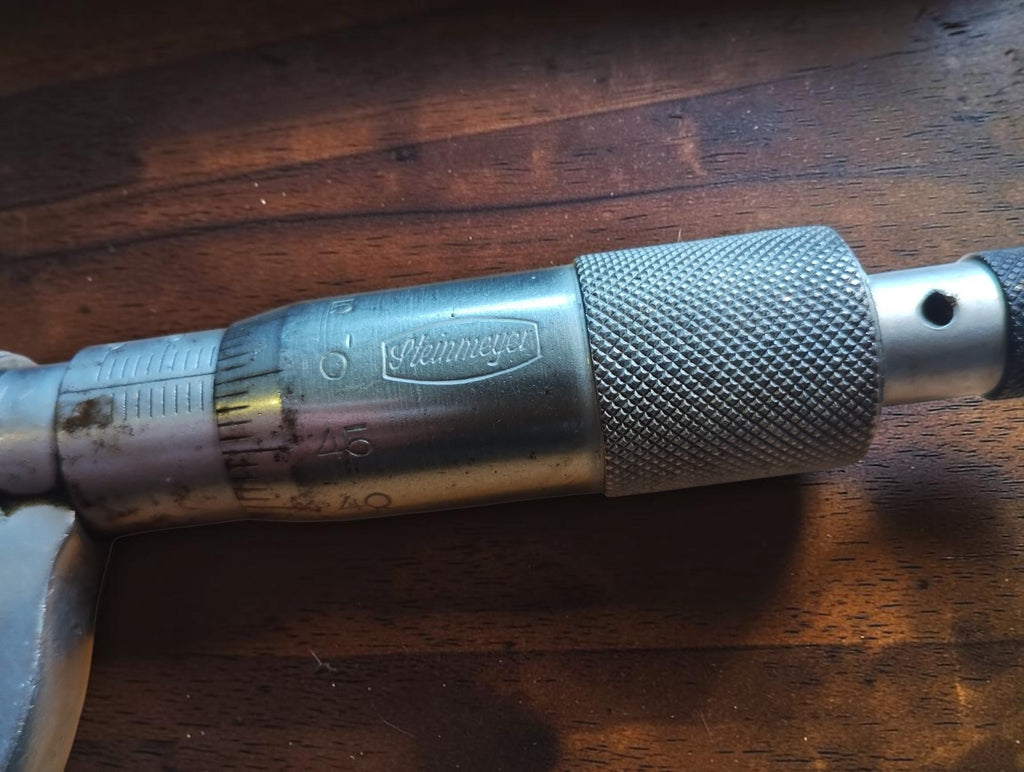 Close-up of the Steinmeyer name, graduated scale and knurled thimble on the vintage micrometer
