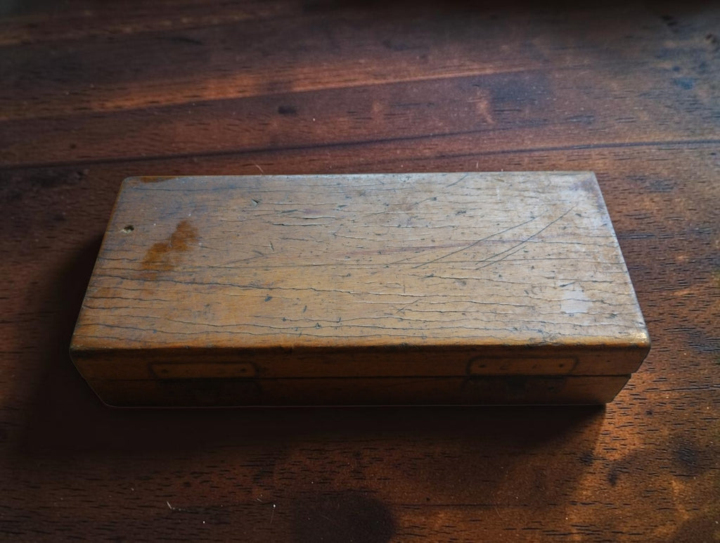 Closed wooden storage case for the Steinmeyer micrometer, showing scratches and signs of age

