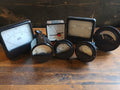 Lot of seven vintage analog panel meters with round and square dials, including AEG milliamp meters.
